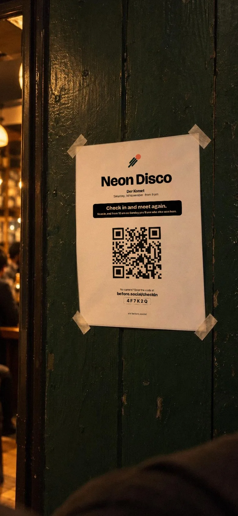 View through a phone camera at the poster on the wall by the entrance, with QR code: Neon Disco. Check in and meet again.